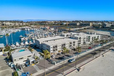 an aerial view of a marina with buildings and boats at 307B Steps from the sand! Freshly Decorated with Harbor Views in Oceanside