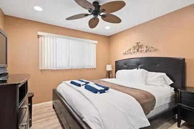 a bedroom with a large bed with a ceiling fan at 309A - Ocean and Beach View in Oceanside