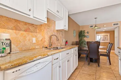 a kitchen with white cabinets and a sink at 309A - Ocean and Beach View in Oceanside