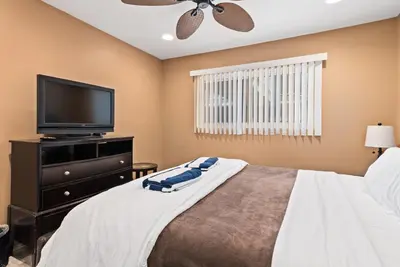 a bedroom with a bed and a flat screen tv at 309A - Ocean and Beach View in Oceanside