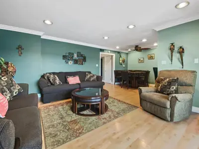a living room with a couch and a table at 311B Harbor Views and Steps to the Sand in Oceanside