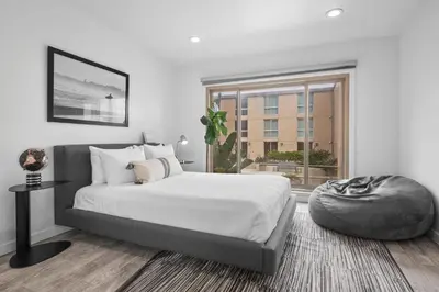 a bedroom with a bed and a large window at Beachfront Oasis - 30-Night Minimum in San Diego