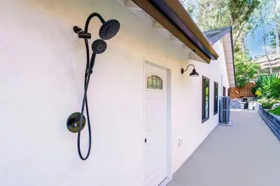 a shower hanging on the side of a house at Poppy Cottage in Carlsbad