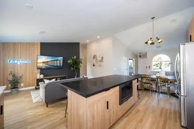an open kitchen and living room with a large counter top at Entire house - 4 Bedroom & 2 Bath, 5 Min to Beach in Oceanside