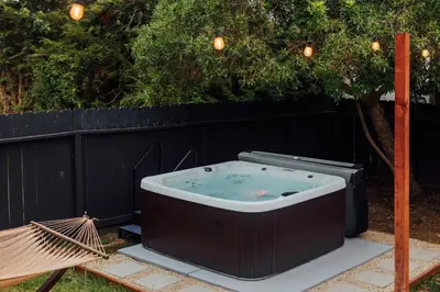 a hot tub in a yard next to a fence at Entire house - 4 Bedroom & 2 Bath, 5 Min to Beach in Oceanside