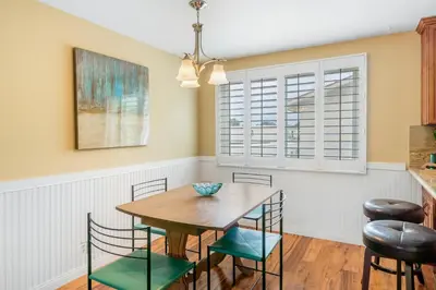 a dining room with a wooden table and chairs at Juniper Coastal Home - 30-Night Minimum in Carlsbad