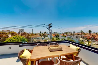 a table and chairs on a balcony with a view at Seaside Serenity Retreat in Oceanside