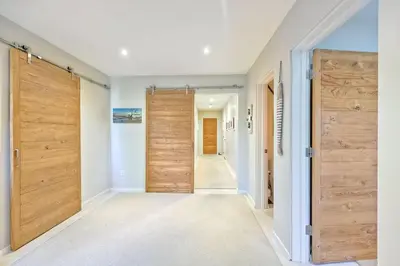 a hallway with wooden doors in a house at Bali Hai, Luxury, High-End Encinitas Home, Large Outdoor Living Area in Encinitas