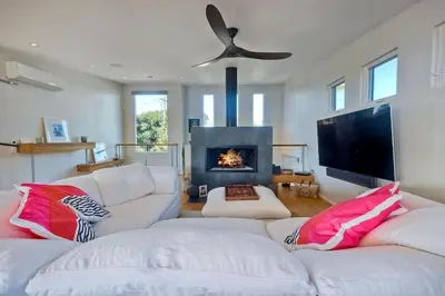 a living room with two white couches and a fireplace at Bali Hai, Luxury, High-End Encinitas Home, Large Outdoor Living Area in Encinitas