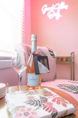 a bottle of wine and a glass on a table at Sundown Sanctuary in National City in National City