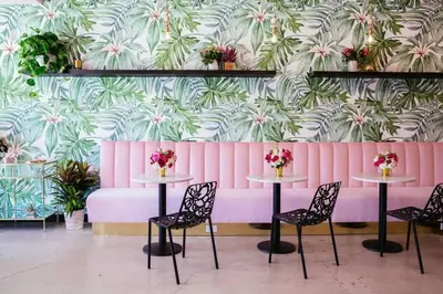 a room with tables and chairs and a pink wall at North Park Retreat - Trendy - Tranquil - Vibrant in San Diego