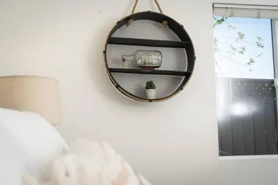 a mirror hanging on a wall next to a window at North Park Retreat - Trendy - Tranquil - Vibrant in San Diego