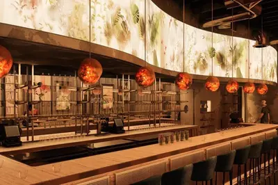 a restaurant with a bar with a long counter and lights at North Park Retreat - Trendy - Tranquil - Vibrant in San Diego