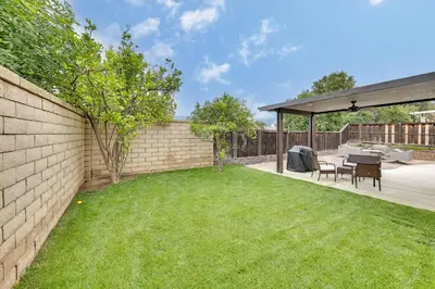 a backyard with a brick wall and a table and chairs at Lake Elsinore Vacation Rental about 4 Mi to the Lake! in Lake Elsinore