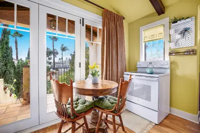 a kitchen with a table and chairs and a window at Spanish Style Cozy Studio in San Diego