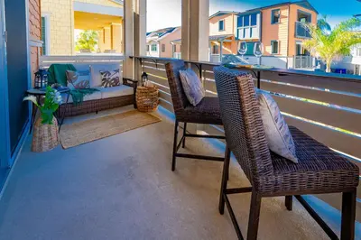 a balcony with two chairs and a couch on it at Pristine and Luxe, Steps to Mission Beach and Bay! in San Diego