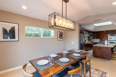 a dining room with a wooden table and chairs at Sumptuous Coastal Hideaway in Oceanside