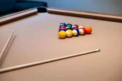 a group of cue balls on a pool table at Sumptuous Coastal Hideaway in Oceanside