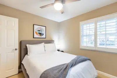 a bedroom with a white bed and a window at Sumptuous Coastal Hideaway in Oceanside