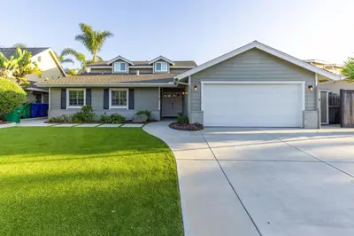 a house with a driveway and a garage at Sumptuous Coastal Hideaway in Oceanside