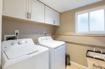 a laundry room with a white washer and dryer at Sumptuous Coastal Hideaway in Oceanside