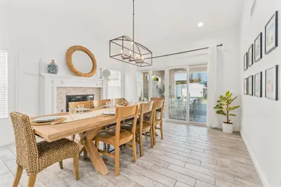 a dining room with a table and chairs and a fireplace at Luxury poolside « Villa Descanso » with heated pool and Spa! Close to San Diego/ Legoland in Oceanside