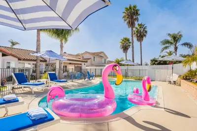 two pink flamingos in a swimming pool at a house at Luxury poolside « Villa Descanso » with heated pool and Spa! Close to San Diego/ Legoland in Oceanside