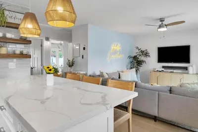 a kitchen and living room with a white counter top at Colorful & Comfy Gem Close to Beach - Yard - Pkg in Encinitas