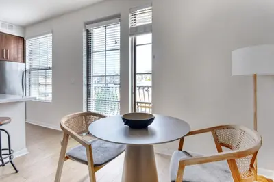 a kitchen and dining room with a table and chairs at Little Italy studio w gym pool nr light rail SAN-6 in San Diego