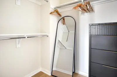 a mirror in a kitchen next to a refrigerator at Little Italy studio w gym pool nr light rail SAN-6 in San Diego