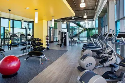 a gym with treadmills and exercise equipment in a building at Little Italy studio w gym pool nr light rail SAN-6 in San Diego