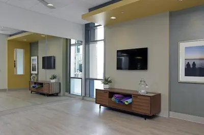 a living room with a tv on a wall at Little Italy studio w gym pool nr light rail SAN-6 in San Diego