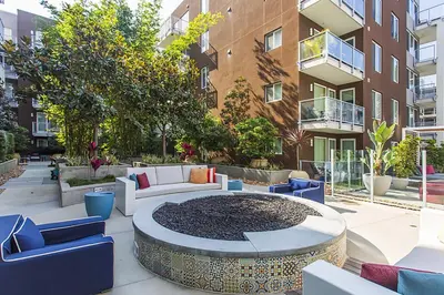a patio with a couch and chairs in front of a building at Little Italy studio w gym pool nr light rail SAN-6 in San Diego