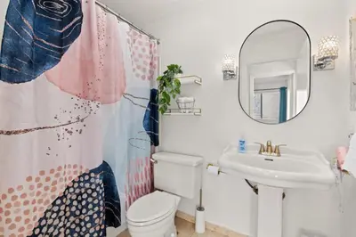 a bathroom with a sink and a toilet and a mirror at Grand Desire - Vibrant - Luxury - Beachside treat in San Diego