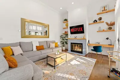 a living room with a couch and a fireplace at Grand Desire - Vibrant - Luxury - Beachside treat in San Diego