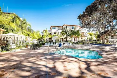 a swimming pool in a courtyard with palm trees at Luxury Villa at Omni La Costa Resort & Spa in Carlsbad