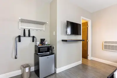 a kitchen with a refrigerator and a microwave at Hotel Aqua Mar in San Diego