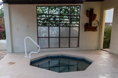 a swimming pool in the middle of a room with windows at Poolside Splendor! Spacious De Anza Golf Club Home in Borrego Springs