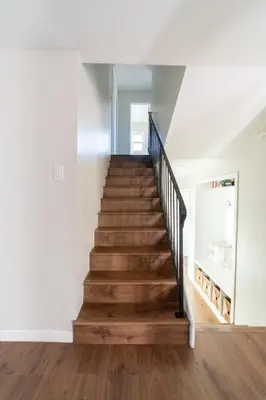 a staircase in a home with white walls and wooden floors at 4Bd, Family Friendly, Fun Yard, Close to Beaches! in Oceanside