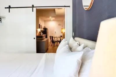 a bedroom with a white bed with white pillows at Ambient Oasis in the Heart of San Diego in San Diego