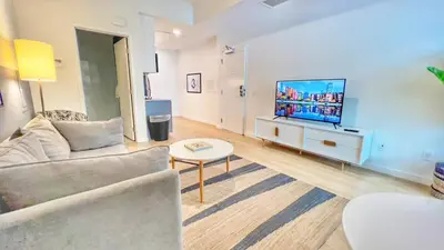 a living room with a couch and a flat screen tv at Cozy Couple's Corner in Downtown San Diego in San Diego