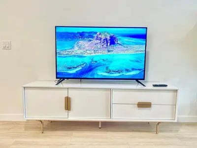 a flat screen tv sitting on top of a white cabinet at Cozy Couple's Corner in Downtown San Diego in San Diego
