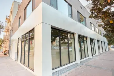 a building with large windows on a city street at Cozy Couple's Corner in Downtown San Diego in San Diego
