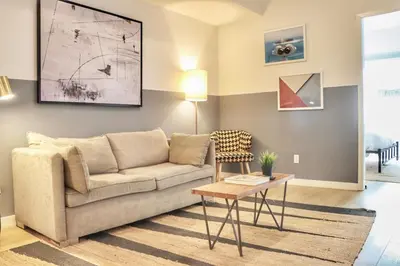 a living room with a couch and a table at Boutique Suite in Downtown San Diego in San Diego