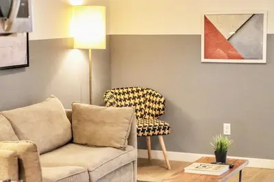 a living room with a couch and a chair at Boutique Suite in Downtown San Diego in San Diego