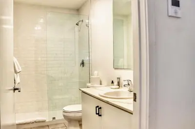 a bathroom with a toilet and a sink and a shower at Boutique Suite in Downtown San Diego in San Diego
