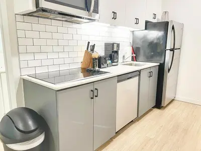 a small kitchen with a sink and a refrigerator at Executive Escape in Downtown San Diego in San Diego