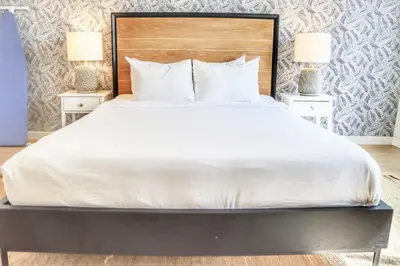 a large bed with white sheets and pillows at Executive Escape in Downtown San Diego in San Diego