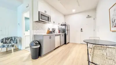 a kitchen with a refrigerator and a table in a room at Executive Escape in Downtown San Diego in San Diego