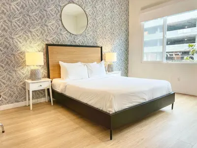 a bedroom with a bed and a mirror on the wall at Fabulous Urban Retreat in San Diego in San Diego
